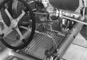 Auf diesem Foto des Rolling Chassis sieht man die aufgeschweißten Ösen am Rahmen, durch die die Bänder geführt werden, die die Spritzwand positionieren