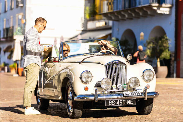 A British Drophead Coupé with Swiss registration under review by the jury—a concours atmosphere in the streets of Ascona