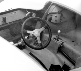 Ungeliebter Arbeitsplatz: ungewohnt flach liegendes Lenkrad, eine der Folgen des kurzen Radstands. Rechts die H-Schaltung des Dreiganggetriebes mit Drehmomentwandler.