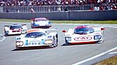Dauer 962 LM (1994) - On the outside of a Le Mans corner, a Dauer Porsche has a slimmer front profile than the Porsche-powered Courage it is overtaking