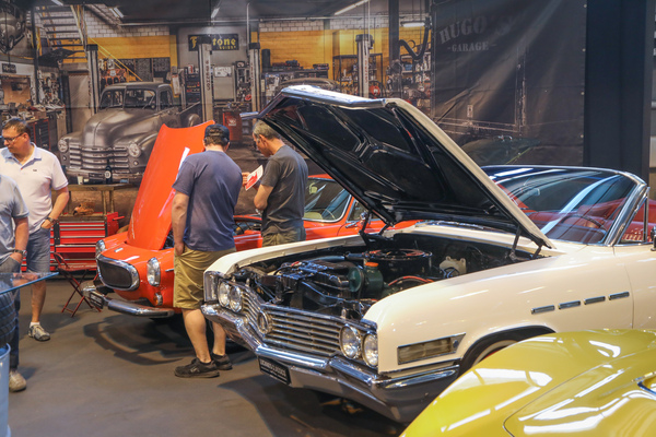 The engine of the Volvo P1800 seems to generate more interest than the V8 next to it - Swiss Classic World Lucerne 2023