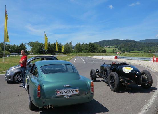 Image: An Aston Martin with a matching James Bond license plate and an Alvis DKC 731