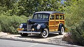 Image: Ford De Luxe "Woodie" Station Wagon (1940) - Lot 302 at the Broad Arrow Monterey Jet Center Auction 2025