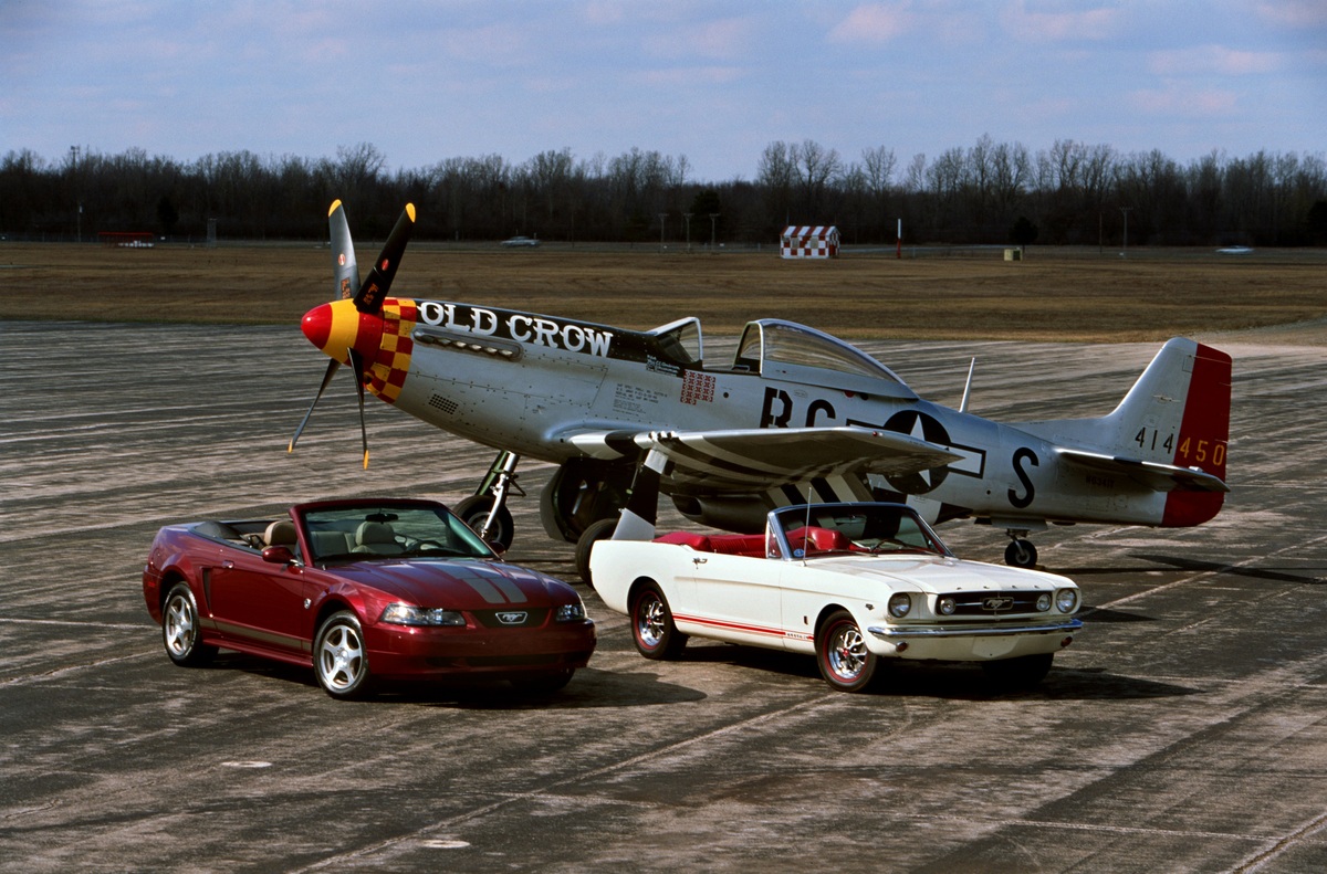 Ford Mustang (2004) - ein Convertible von 2004 neben dem Convertible von 1965 und dem P51-Mustang dahinter