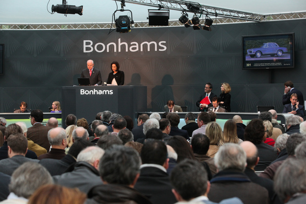 Image: James Knight auctions a Mercedes-Benz 280 SL for a good cause as the first car lot - Bonhams auction at the Grand Palais in Paris on February 4, 2016