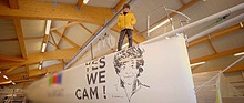 Image: Jean Le Cam above a depiction dedicated to him on a sailing boat