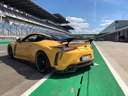 Lexus LC 500 (2021) — The massive rear wing isn't standard equipment; the exhaust tips are paired and integrated into the diffuser, photographed in the pit lane
