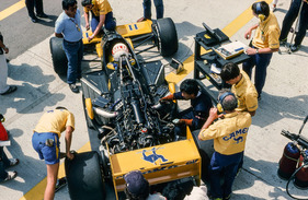 Lotus 99 (1987) - Saturo Nakajima beim GP Frankreich. Ganz rechts im Bild Computerspezialist Peter Wright beim Auslesen der Daten.