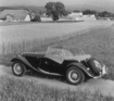 MG Midget Series TF (1954) - Ansicht von schräg hinten, Seitenscheiben montiert