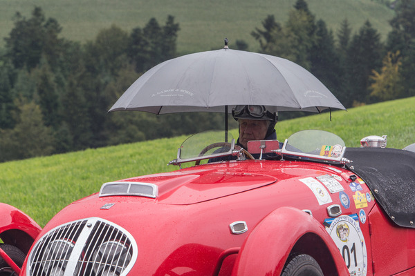 "Man wartet mit Schirm im Auto, ...