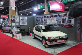 Peugeot 205 GTI (1986) - auf dem Clubstand, im Hintergrund die Konkurrenz von Volkswagen - Rétromobile Paris 2020