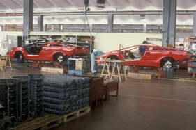 Produktion des Lamborghini Countach im Jahre 1988 - die Fahrzeuge rollen auf kleinen Wagen über Schienen durch die Produktionshalle