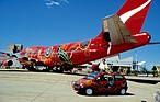 Image: Renault Twingo (1994) - the painted Twingo, in front of a similarly patterned airplane