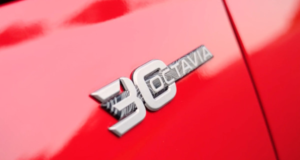Image: Škoda Octavia (2026) — Chrome emblem with a finely lined interior pattern — representing nearly 7.9 million units produced