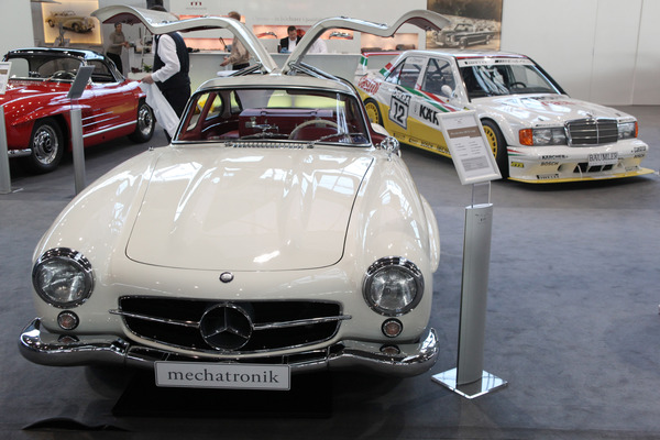 Super classics in front of racing car legends - on the left two Mercedes Benz 300 SL, on the right behind the Mercedes Benz 190 E 2.5-16 Evo II, with which Jörg van Ommen won the 1992 Wunstorf race - Retro Classics Stuttgart 2014
