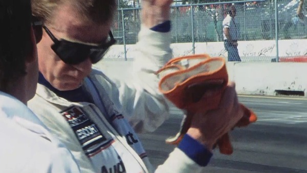 Walter Röhrl erklärt mit viel Gestik, wieviel Grip der Audi 200 in den Kurven aufbaut. Quattro Jahre - Ausschnitt aus dem Film über den Einsatz in der TransAm Serie 1988